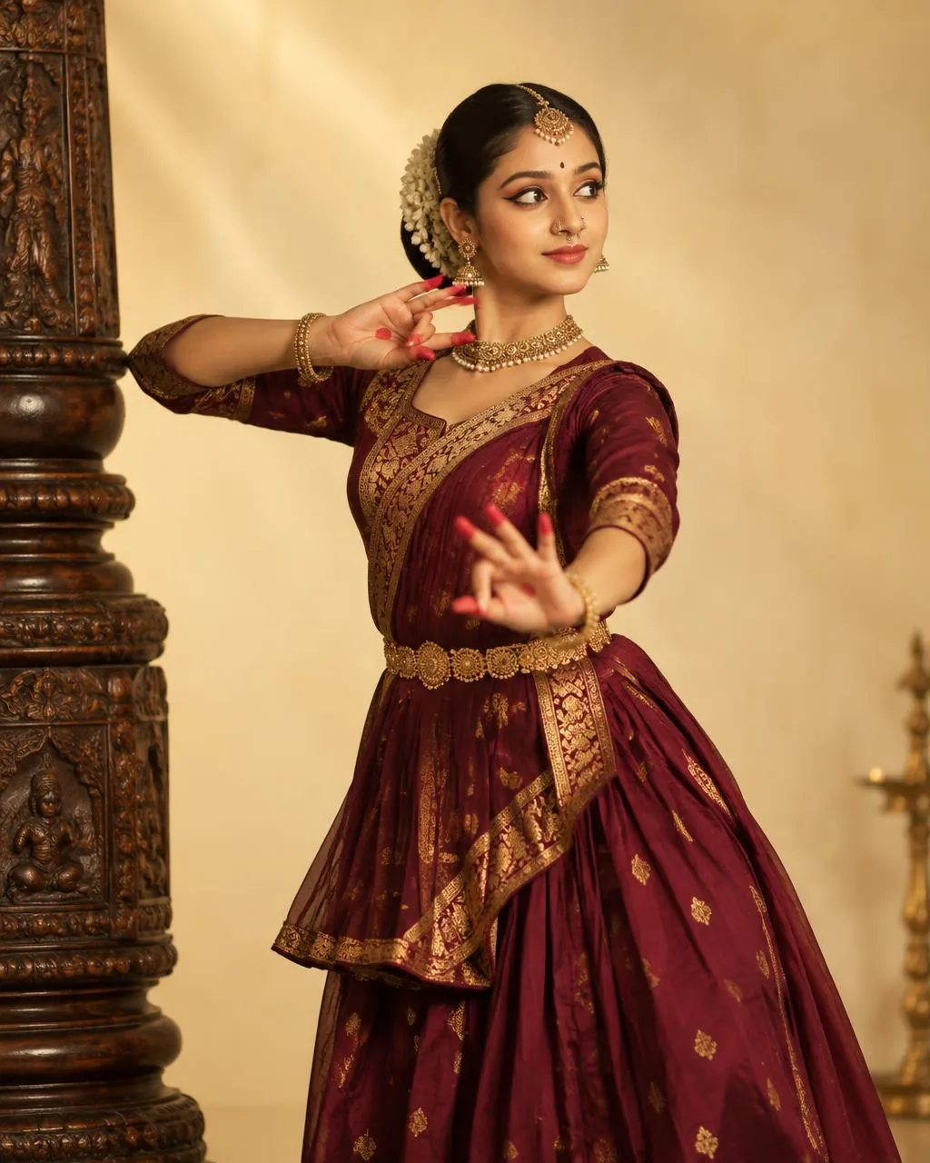 Kathak dancer in maroon and gold costume